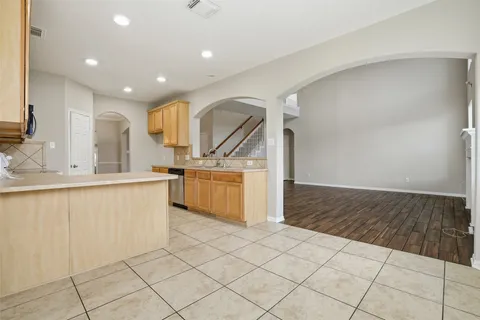 a kitchen with granite countertop a sink and a stove