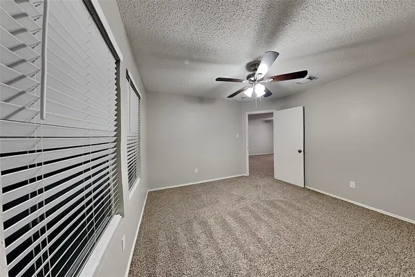 a view of an empty room with a ceiling fan