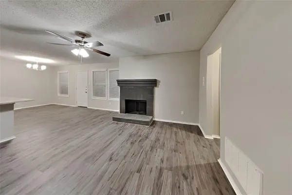 wooden floor in an empty room with a fireplace