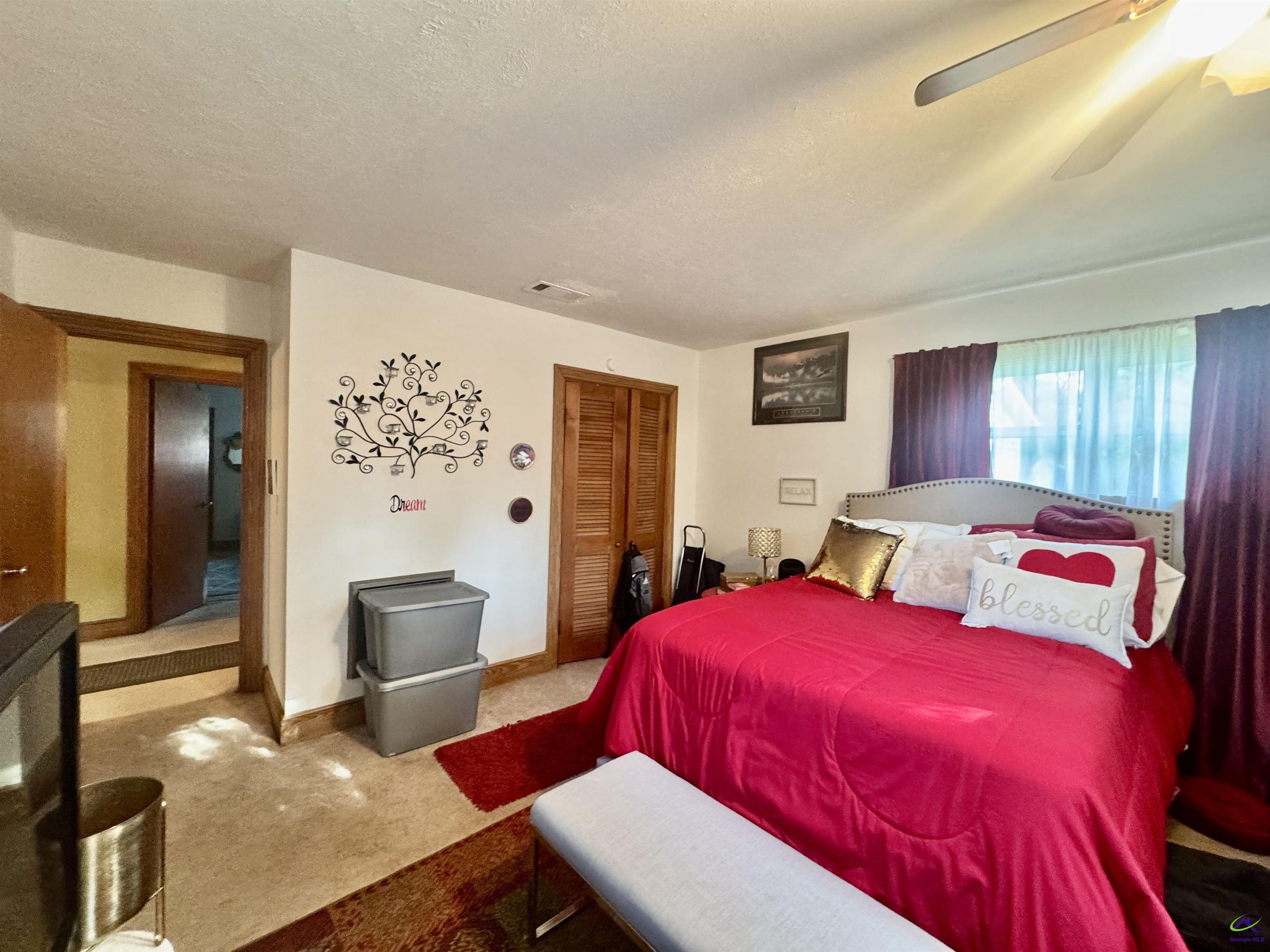 914 Adderton Street Americus, GA 31719 - Photo 24 of 53 a bedroom with a bed and wooden floor