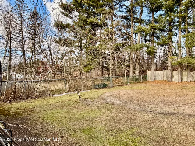 a view of pool with trees in the background