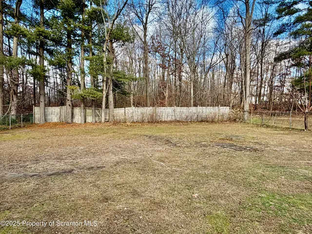 a dining room with furniture a chandelier and wooden floor