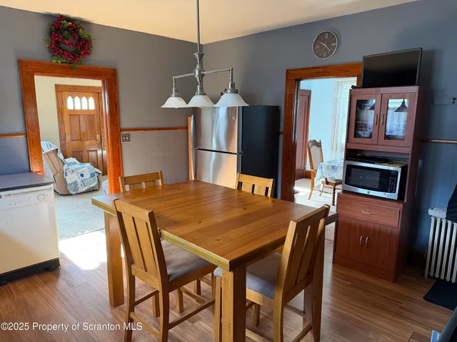 a kitchen with stainless steel appliances granite countertop a refrigerator a stove and a sink