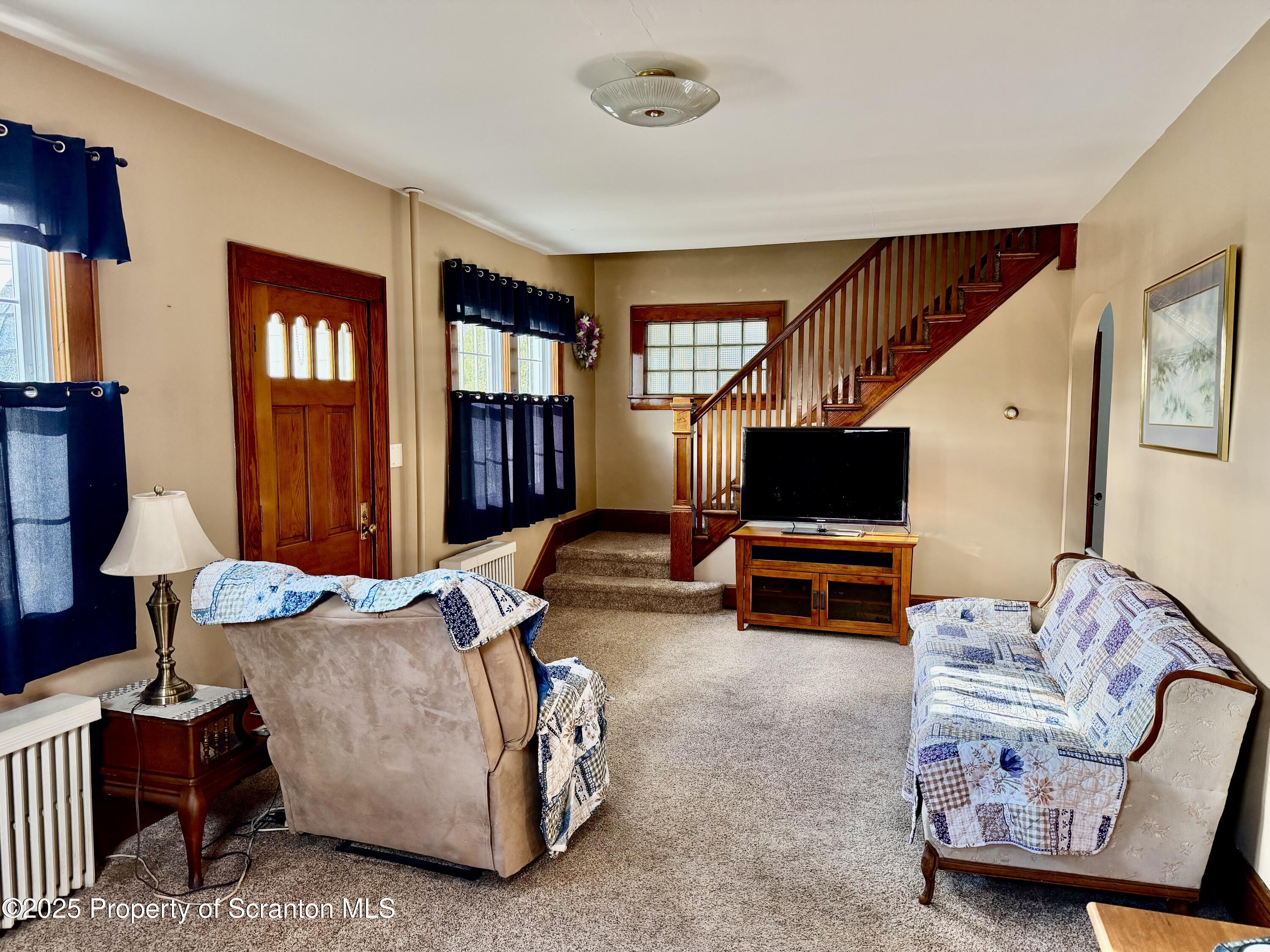 116 South Main Street Archbald, PA 18403 - Photo 18 of 31 a living room with furniture and a flat screen tv