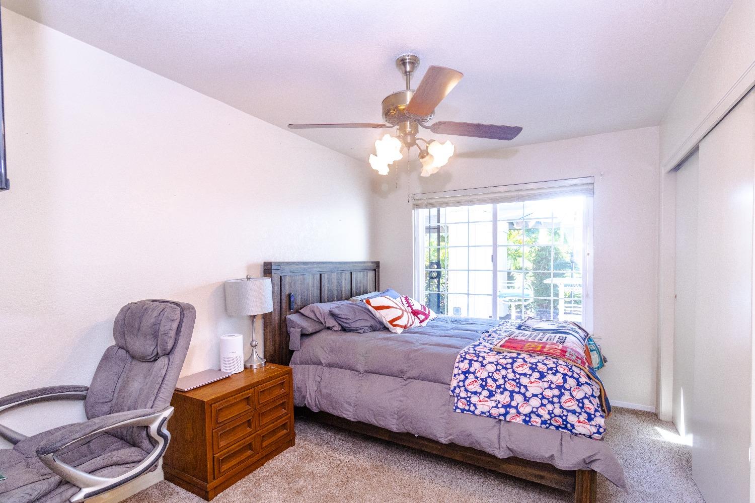 1955 Alamos Avenue Clovis, CA 93611 - Photo 12 of 28 a bedroom with a bed dresser and a window