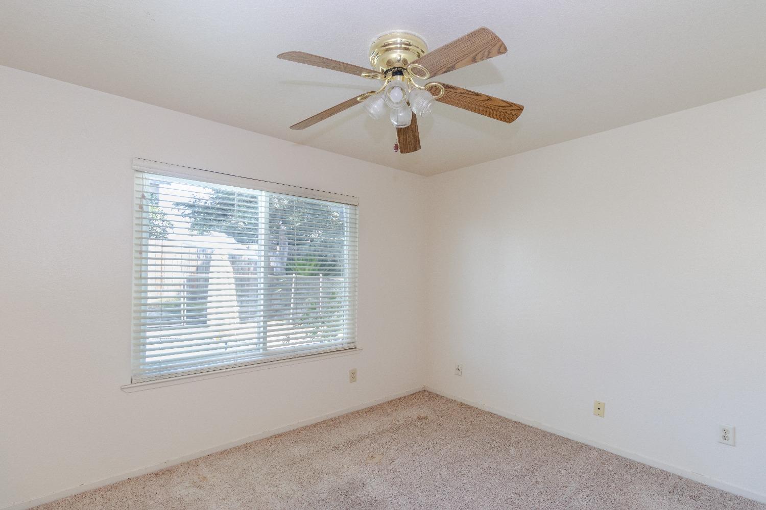 1955 Alamos Avenue Clovis, CA 93611 - Photo 13 of 28 an empty room with a window and a fan