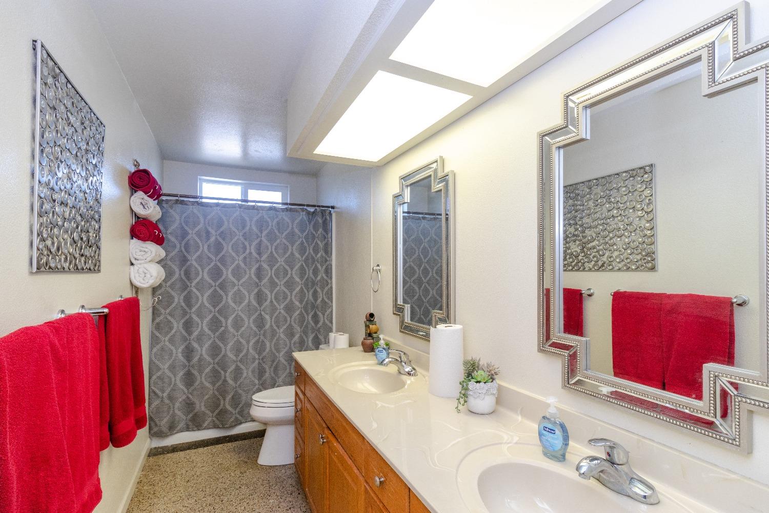 1955 Alamos Avenue Clovis, CA 93611 - Photo 18 of 28 a bathroom with a double vanity sink mirror and shower