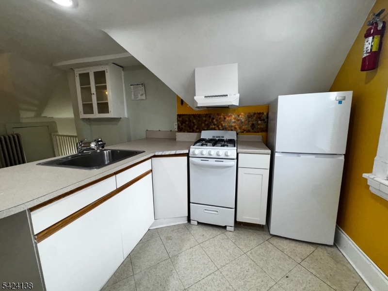 160 Chestnut Street, Unit 2 Montclair, NJ 07042 - Photo 17 of 20 a kitchen with white cabinets and white appliances