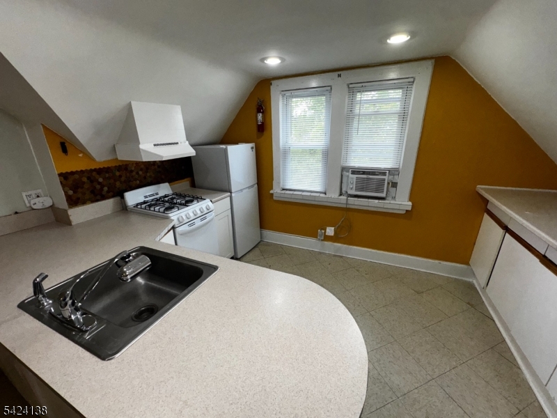 160 Chestnut Street, Unit 2 Montclair, NJ 07042 - Photo 18 of 20 a kitchen with stainless steel appliances a stove a sink and a refrigerator