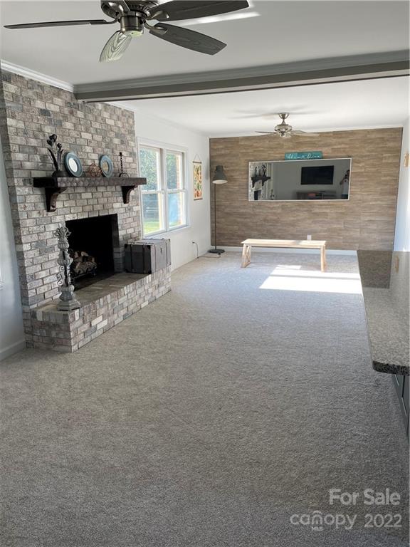 3616 Morgan Mill Road Monroe, NC 28110 - Photo 5 of 19 a view of living room kitchen with furniture and fireplace