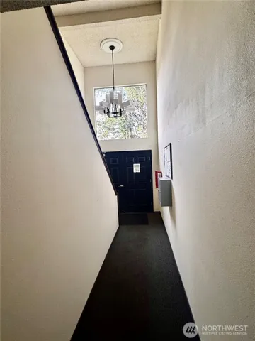 a view of a hallway view with chandelier