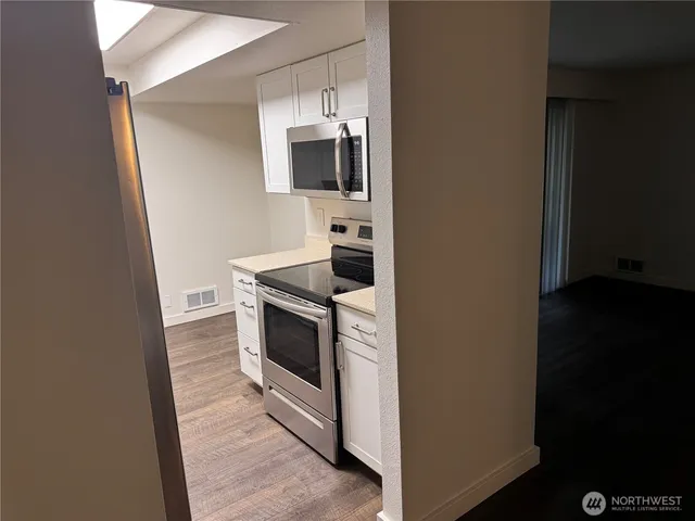 a kitchen with a stove and a microwave