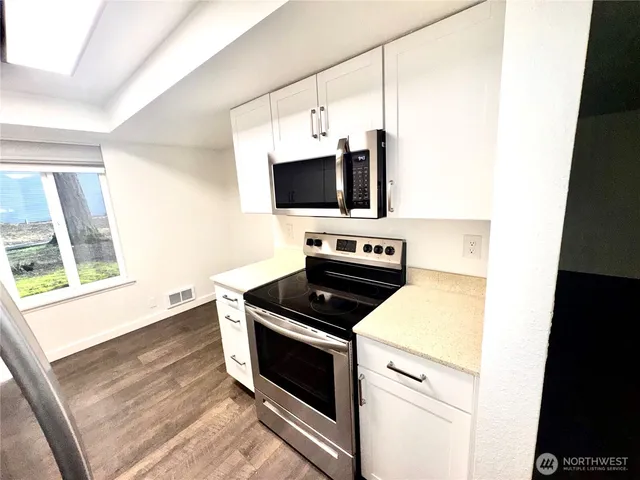 a kitchen with a stove and a microwave