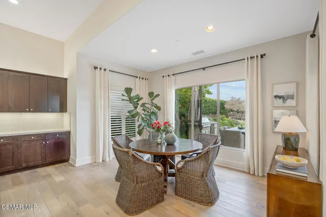 a dining room with furniture window and wooden floor