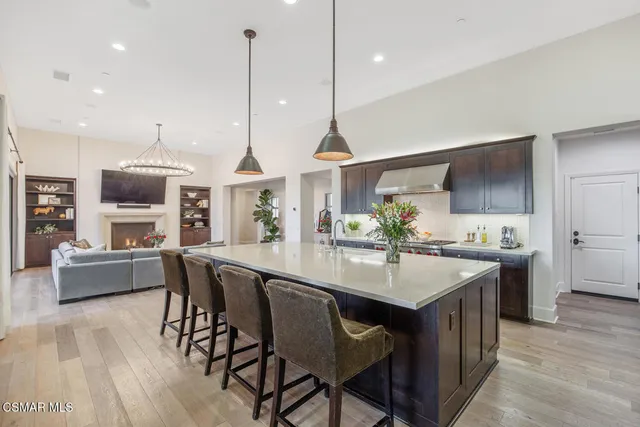 a bedroom with a bed a dresser and a book shelf