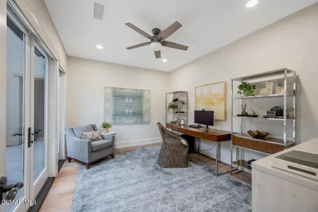 a view of a balcony with chair and wooden floor