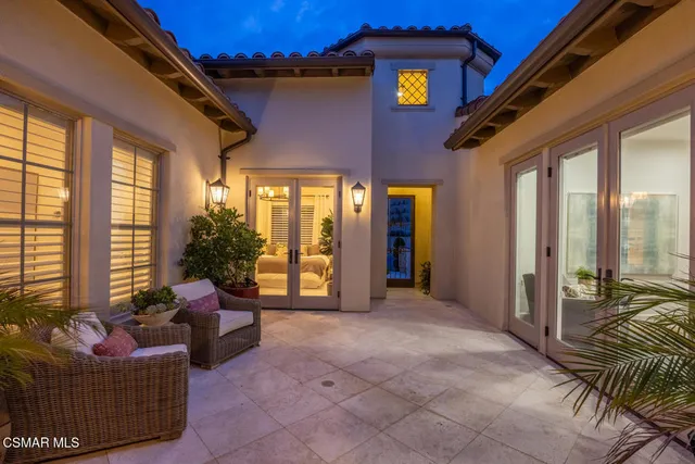 a view of the patio with couches and potted plants