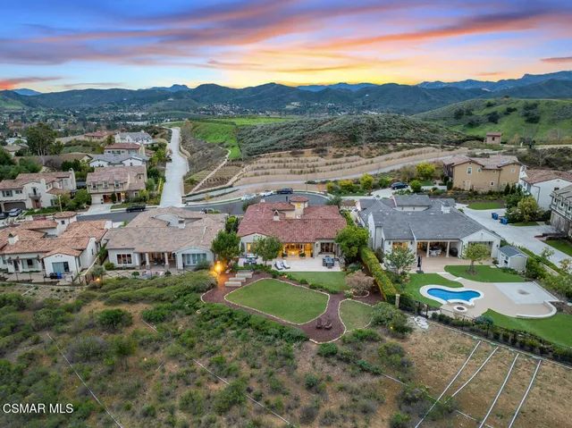 a living room with patio furniture and a floor to ceiling window