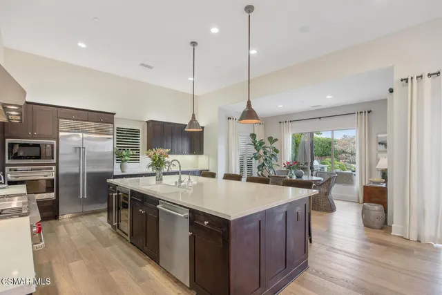 a kitchen with a counter space a sink and cabinets