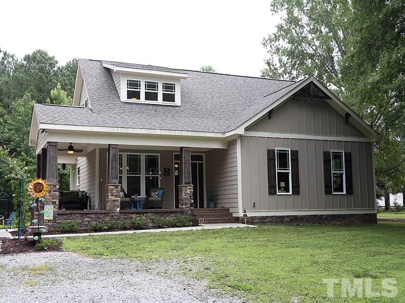 7401 Denlee Road Raleigh, NC 27603 - Photo 1 of 25 a front view of a house with garden