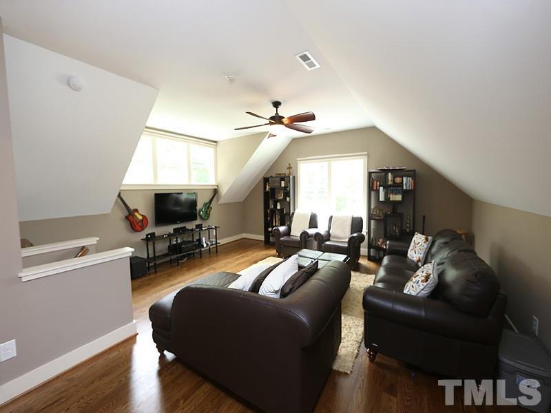 7401 Denlee Road Raleigh, NC 27603 - Photo 11 of 25 a living room with furniture a ceiling fan and a window