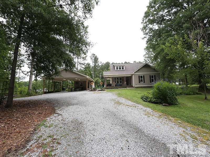 7401 Denlee Road Raleigh, NC 27603 - Photo 15 of 25 a front view of a house with yard and green space