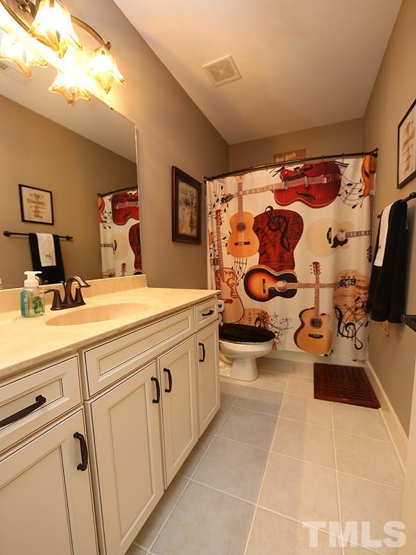 7401 Denlee Road Raleigh, NC 27603 - Photo 18 of 25 a bathroom with a sink mirror and window