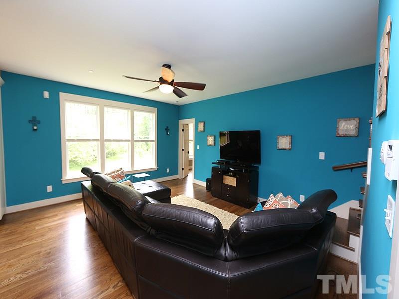 7401 Denlee Road Raleigh, NC 27603 - Photo 19 of 25 a living room with furniture and a flat screen tv