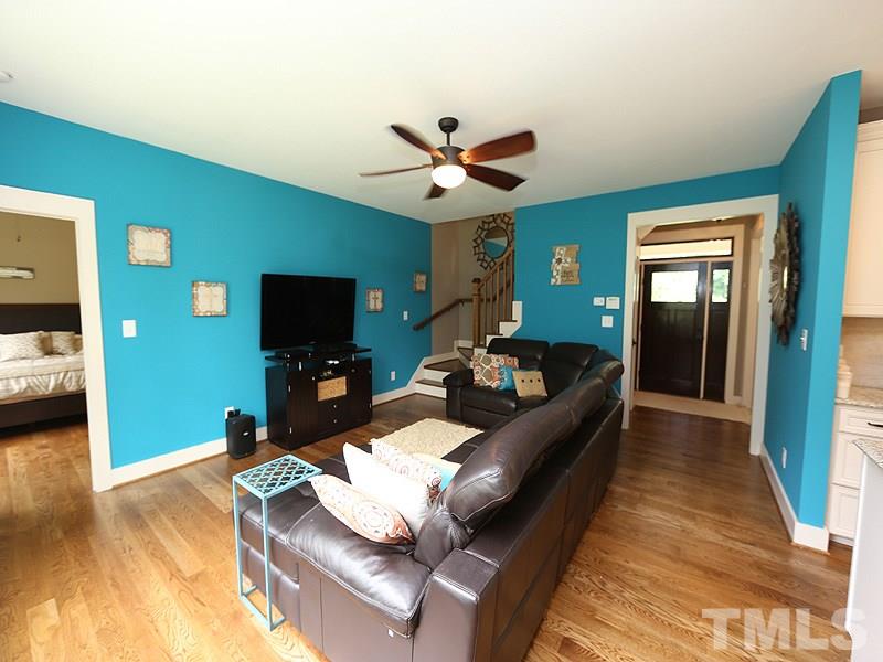 7401 Denlee Road Raleigh, NC 27603 - Photo 20 of 25 a living room with furniture and a flat screen tv