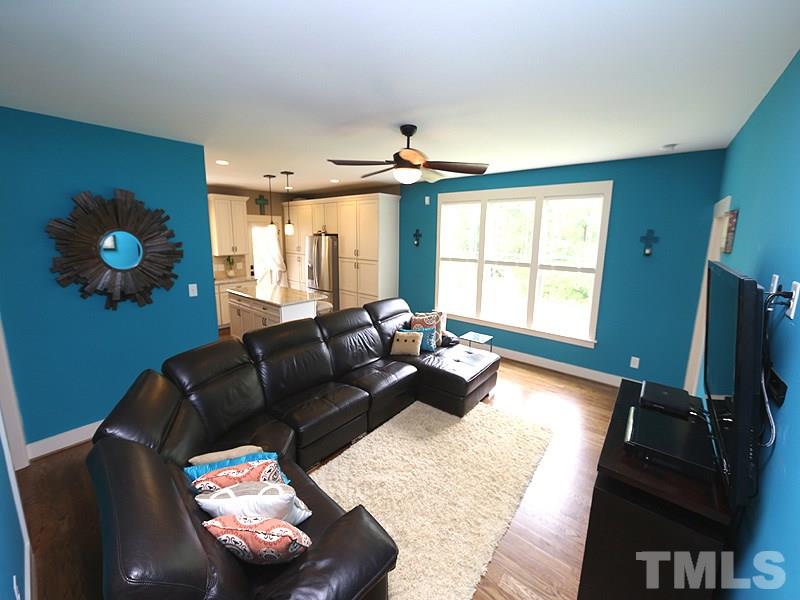 7401 Denlee Road Raleigh, NC 27603 - Photo 21 of 25 a living room with furniture fireplace and a flat screen tv