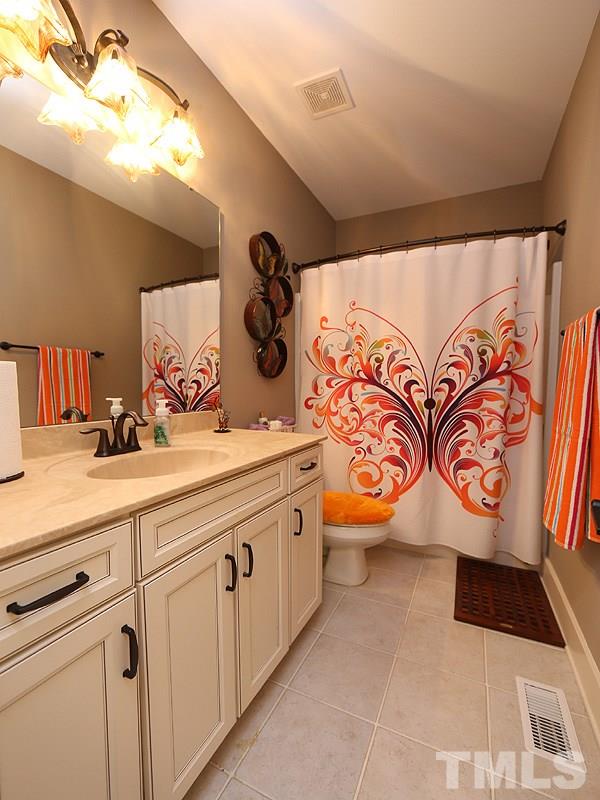 7401 Denlee Road Raleigh, NC 27603 - Photo 22 of 25 a bathroom with a sink and mirror