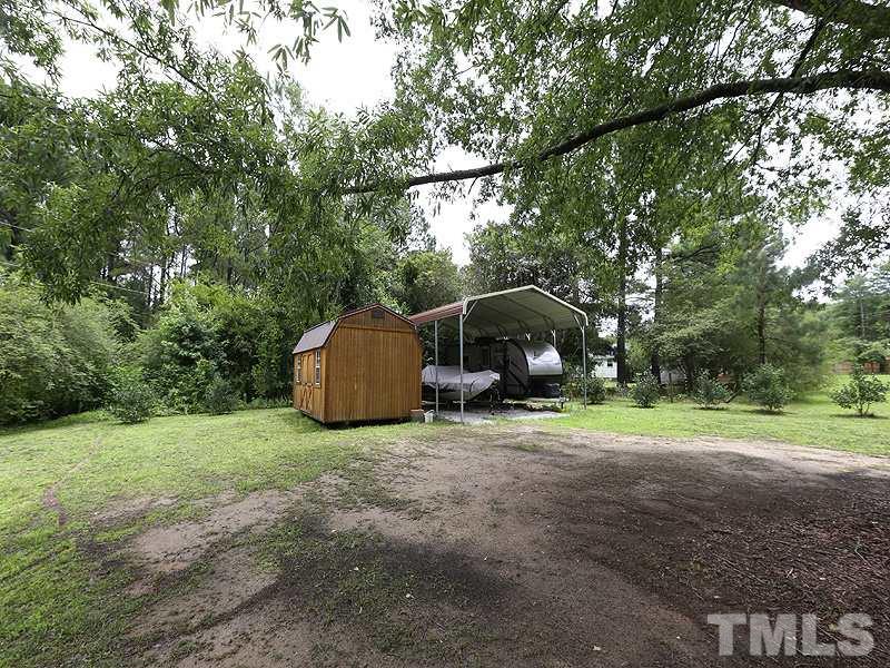 7401 Denlee Road Raleigh, NC 27603 - Photo 25 of 25 a view of a backyard with large trees and plants