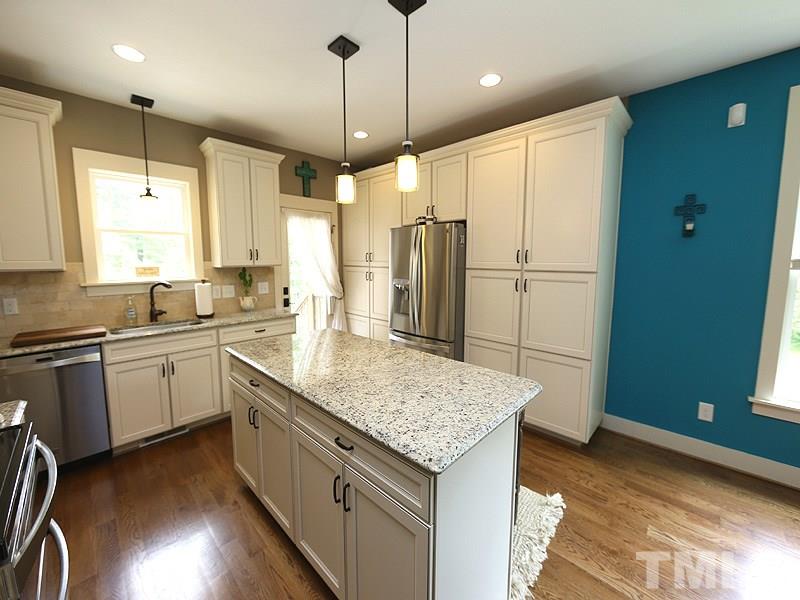 7401 Denlee Road Raleigh, NC 27603 - Photo 5 of 25 a kitchen with stainless steel appliances granite countertop a sink stove and refrigerator