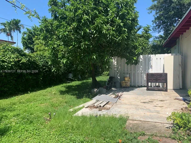 a backyard of a house with yard and trampoline