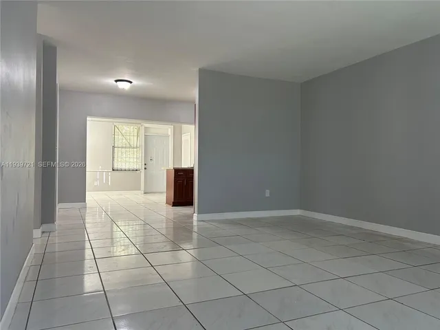 a view of an empty room with a window