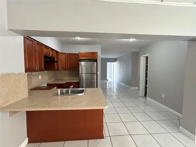 a kitchen with stainless steel appliances a sink stove and refrigerator