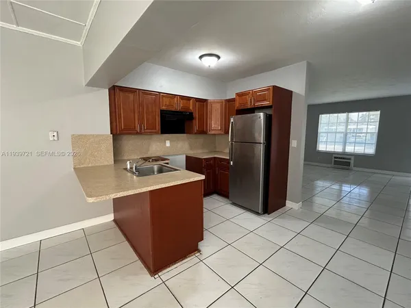 a kitchen with stainless steel appliances granite countertop a refrigerator and a stove