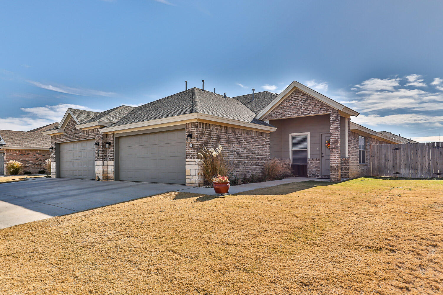5527 121st Street, Unit A Lubbock, TX 79424 - Photo 1 of 41 a front view of a house with a yard