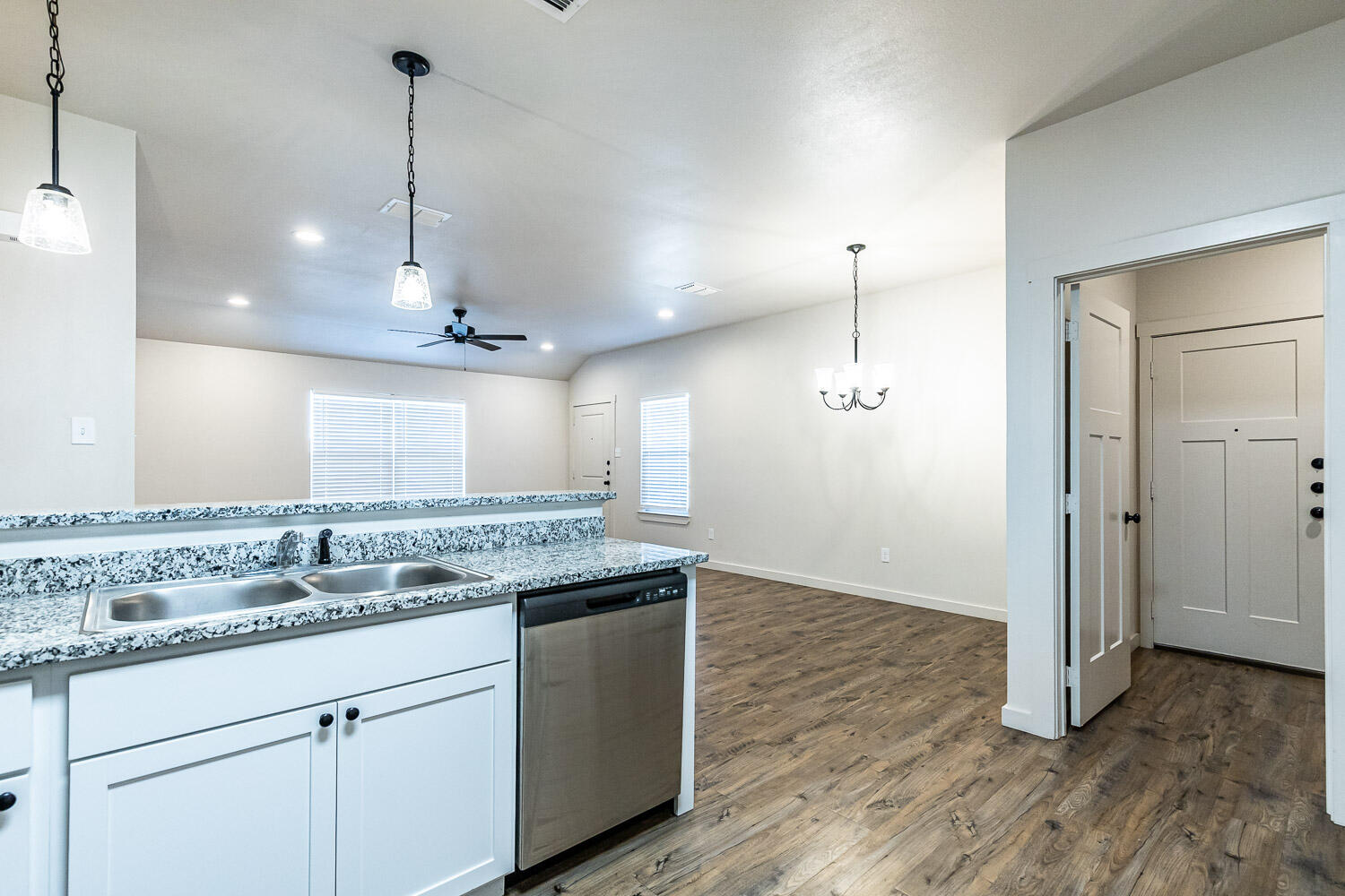 5527 121st Street, Unit A Lubbock, TX 79424 - Photo 19 of 41 a kitchen with kitchen island granite countertop a sink a counter space appliances and cabinets