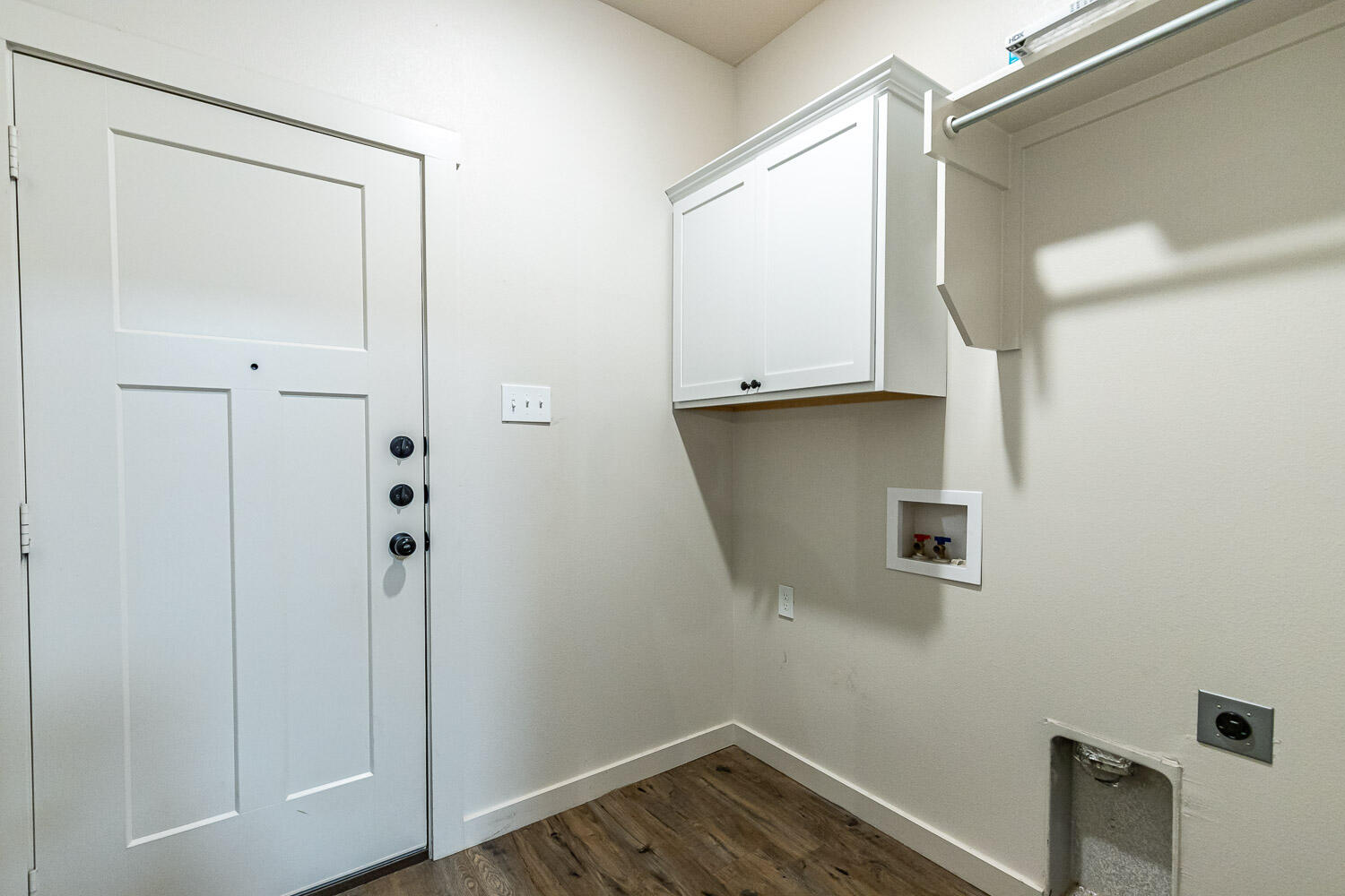 5527 121st Street, Unit A Lubbock, TX 79424 - Photo 22 of 41 a view of storage and utility room with wooden floor