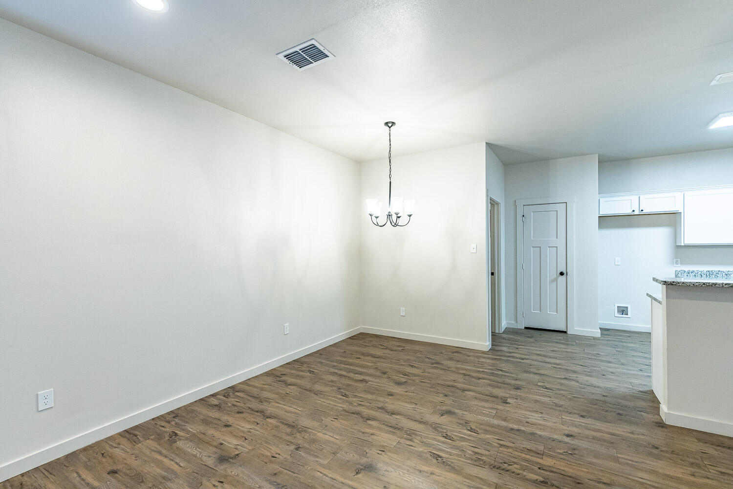 5527 121st Street, Unit A Lubbock, TX 79424 - Photo 8 of 41 a view of an empty room with wooden floor and a window