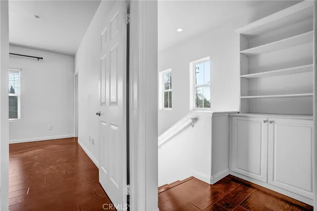 a kitchen with granite countertop a sink and a white wooden cabinets