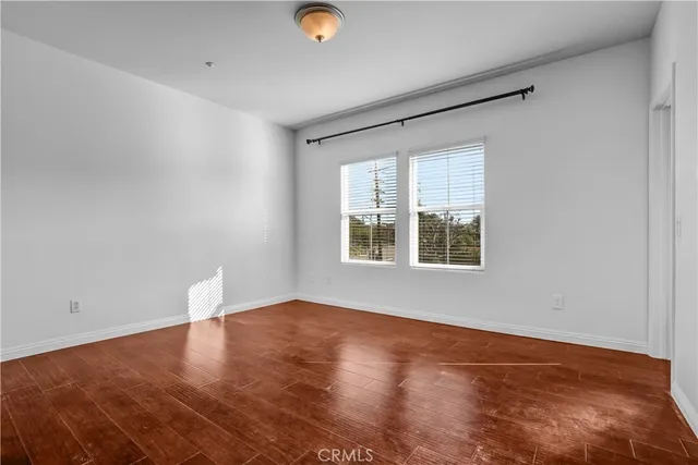 a view of a hallway with wooden floor and entryway