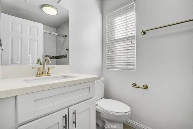 a bathroom with a granite countertop sink a mirror shower and a bathtub