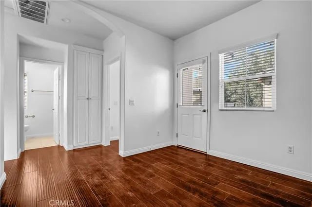 a view of a room with wooden floor and windows