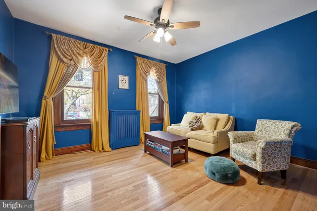 a kitchen with stainless steel appliances granite countertop a refrigerator a sink dishwasher a stove and a dining table with wooden floor