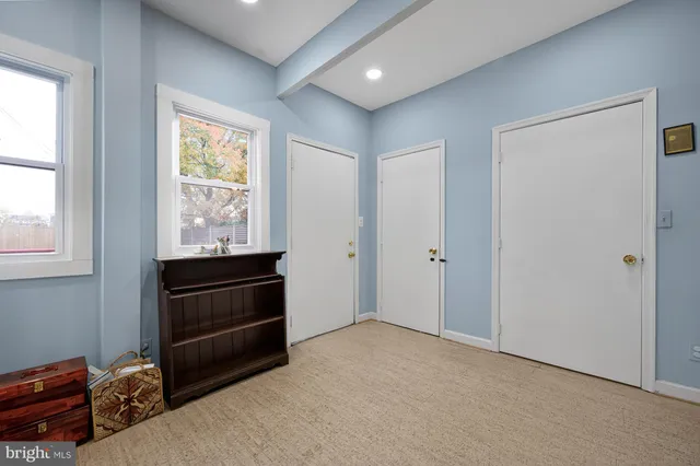 a view of a workspace with furniture and a bookshelf