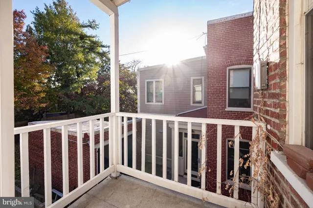 a view of a patio with a dining table and chairs