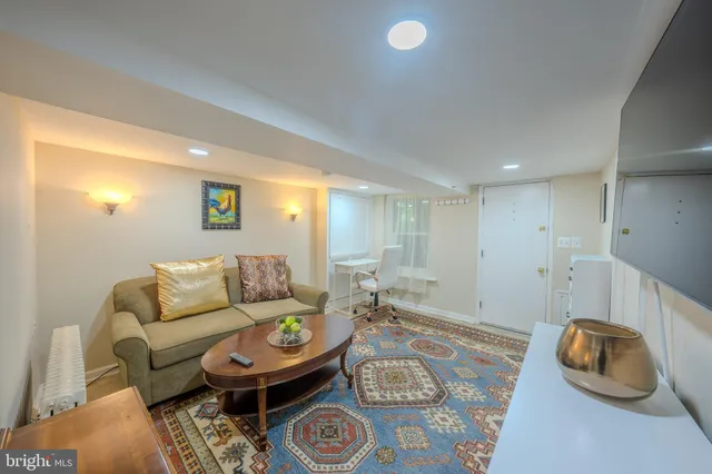 a view of a white house with a yard and a large tree