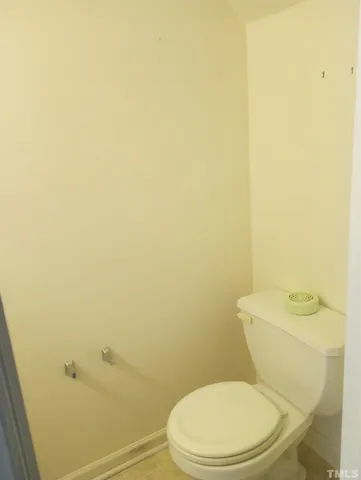 a white toilet sitting next to a shower
